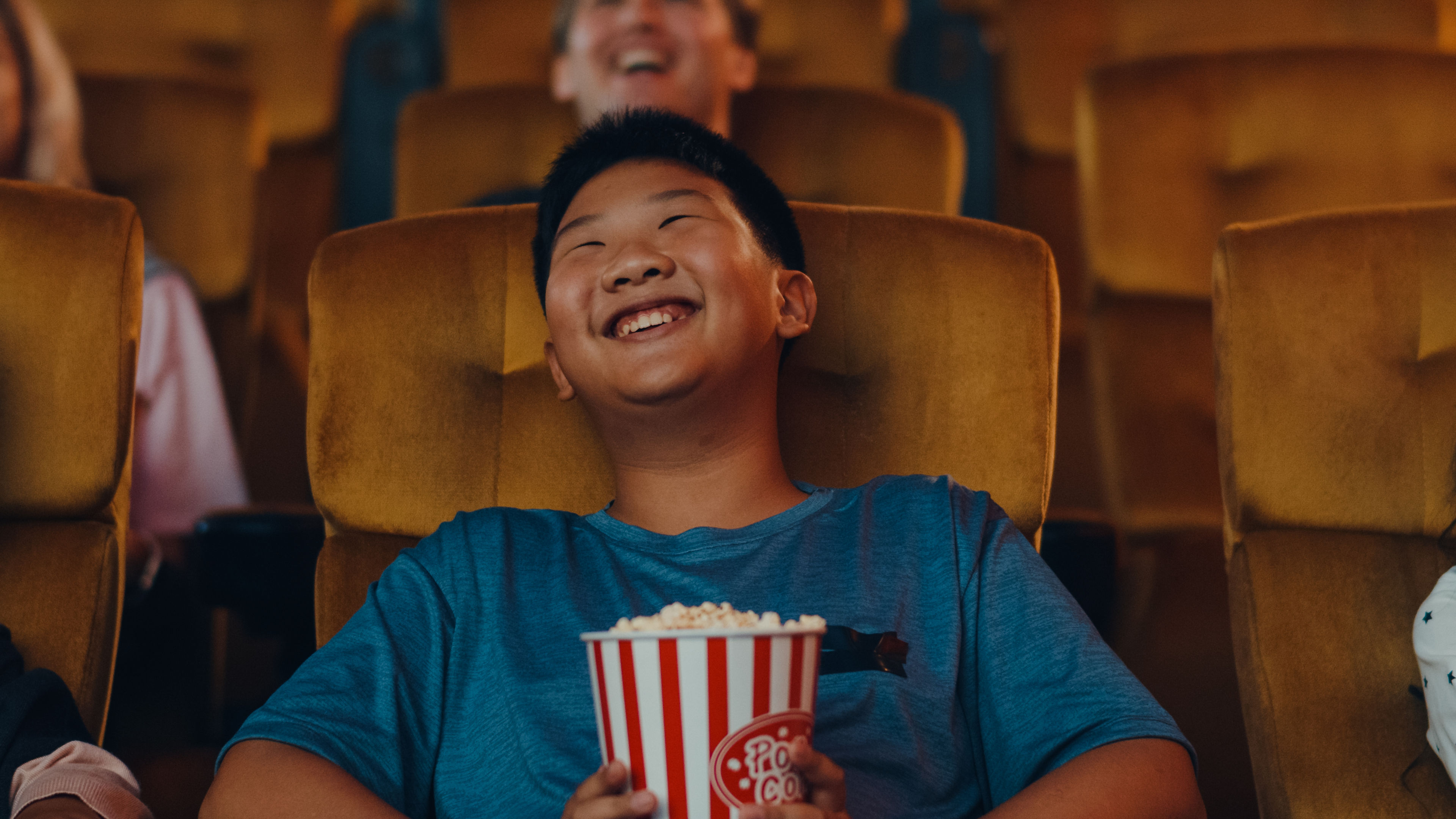 A boy is excited in watching movie