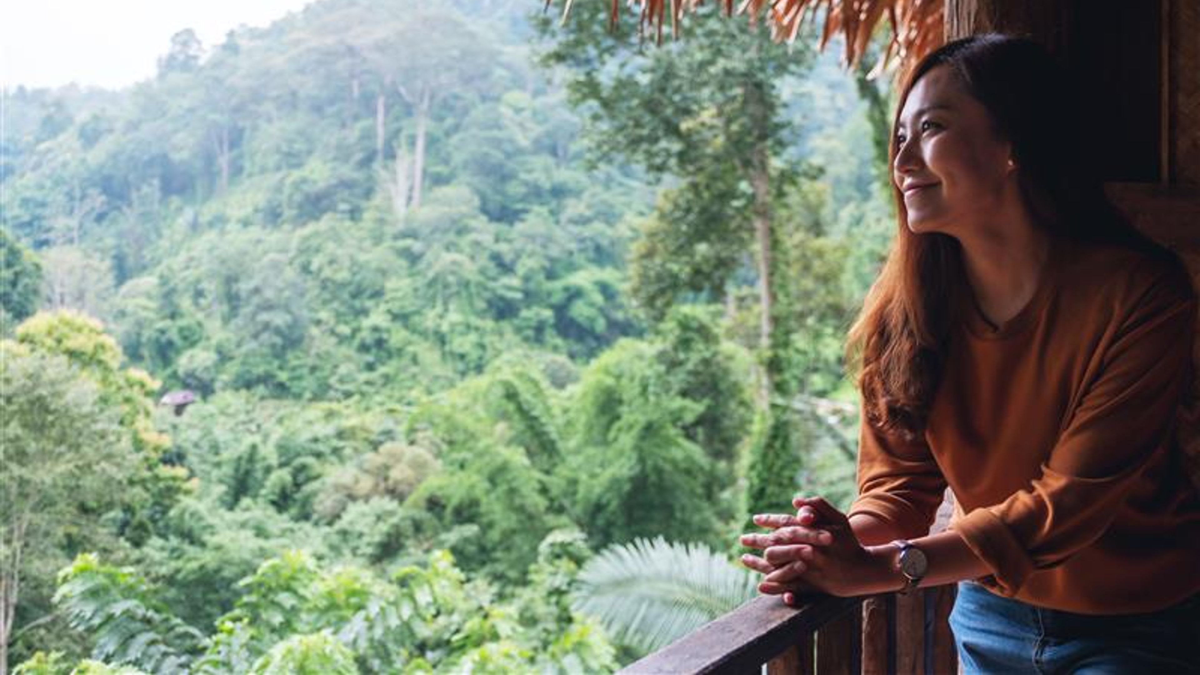 A Woman looking at a view from a balcony