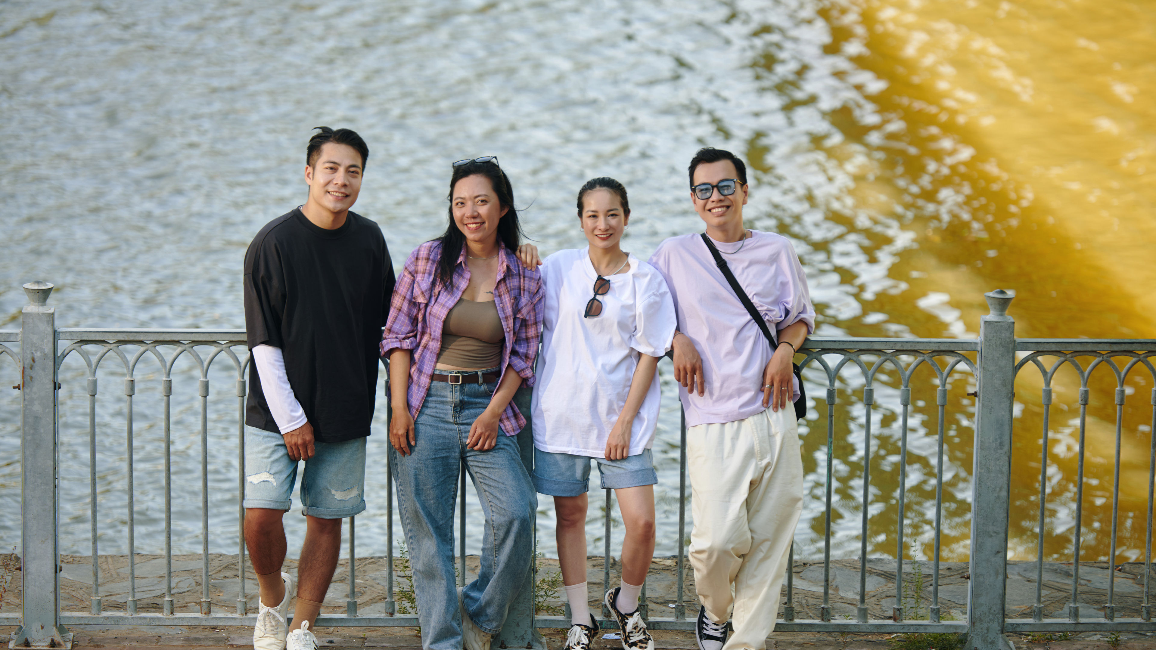Group of friends posing by the water. 