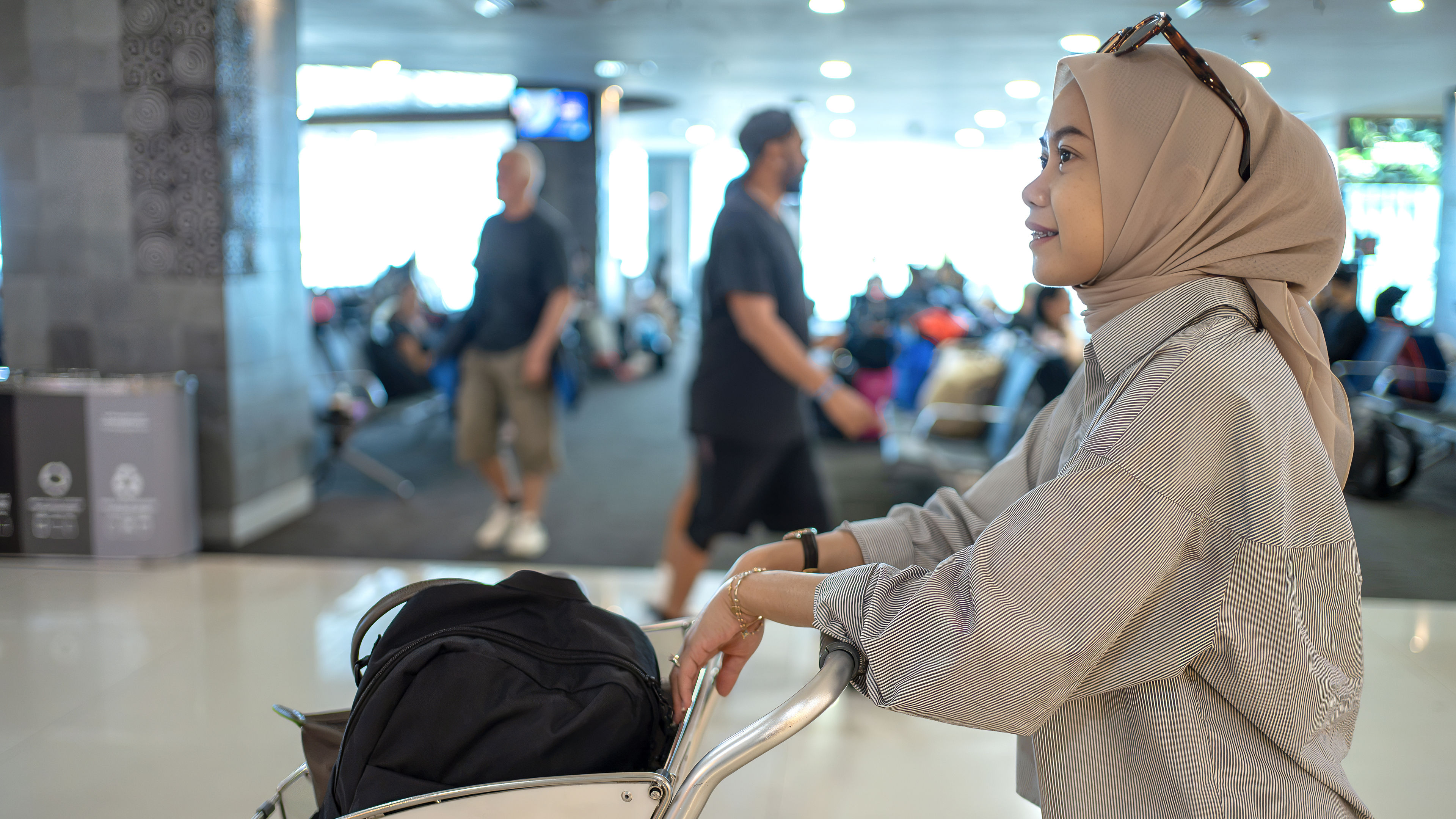 Muslim Woman Pushing Luggage