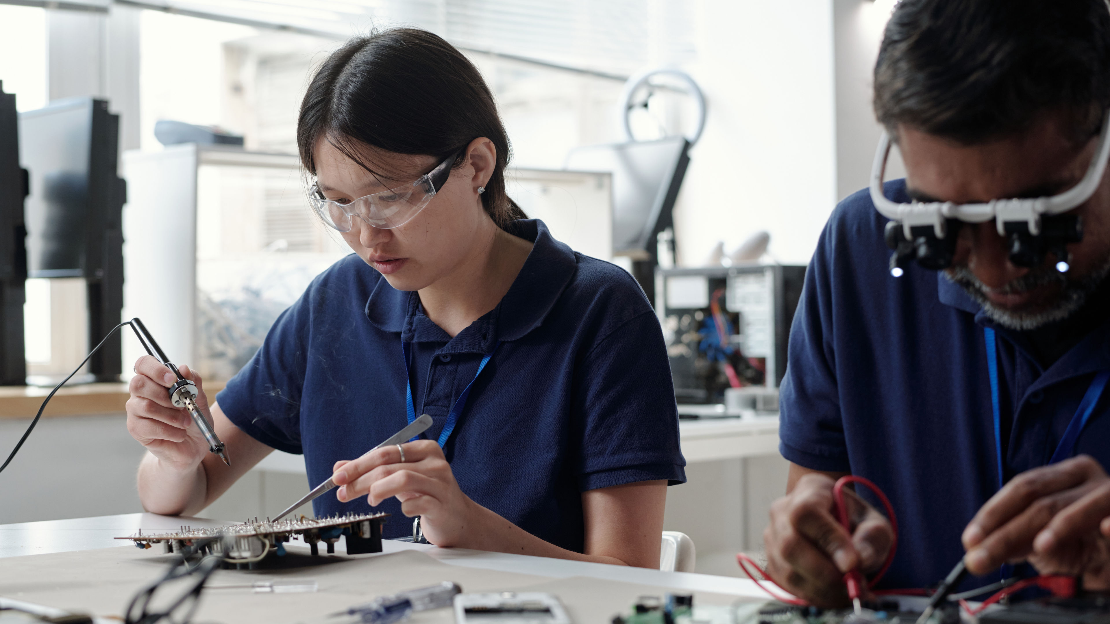 Workers Creating Technological Devices in Office Setting