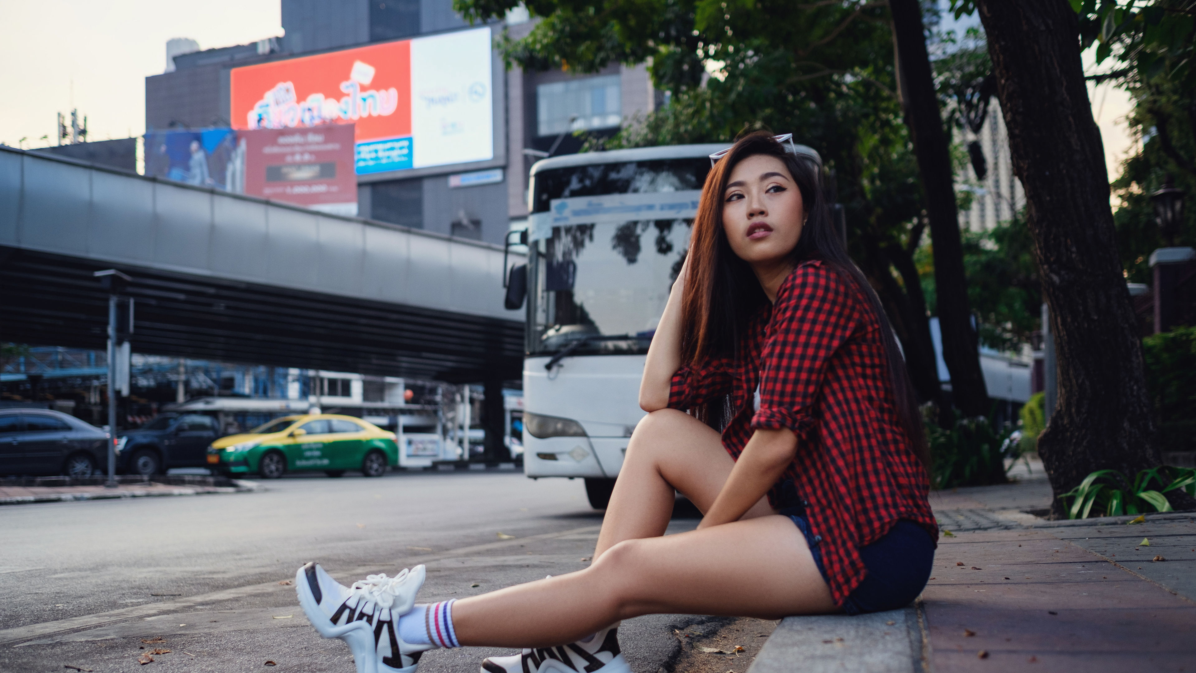Young Woman Lounging on Sidewalk 
